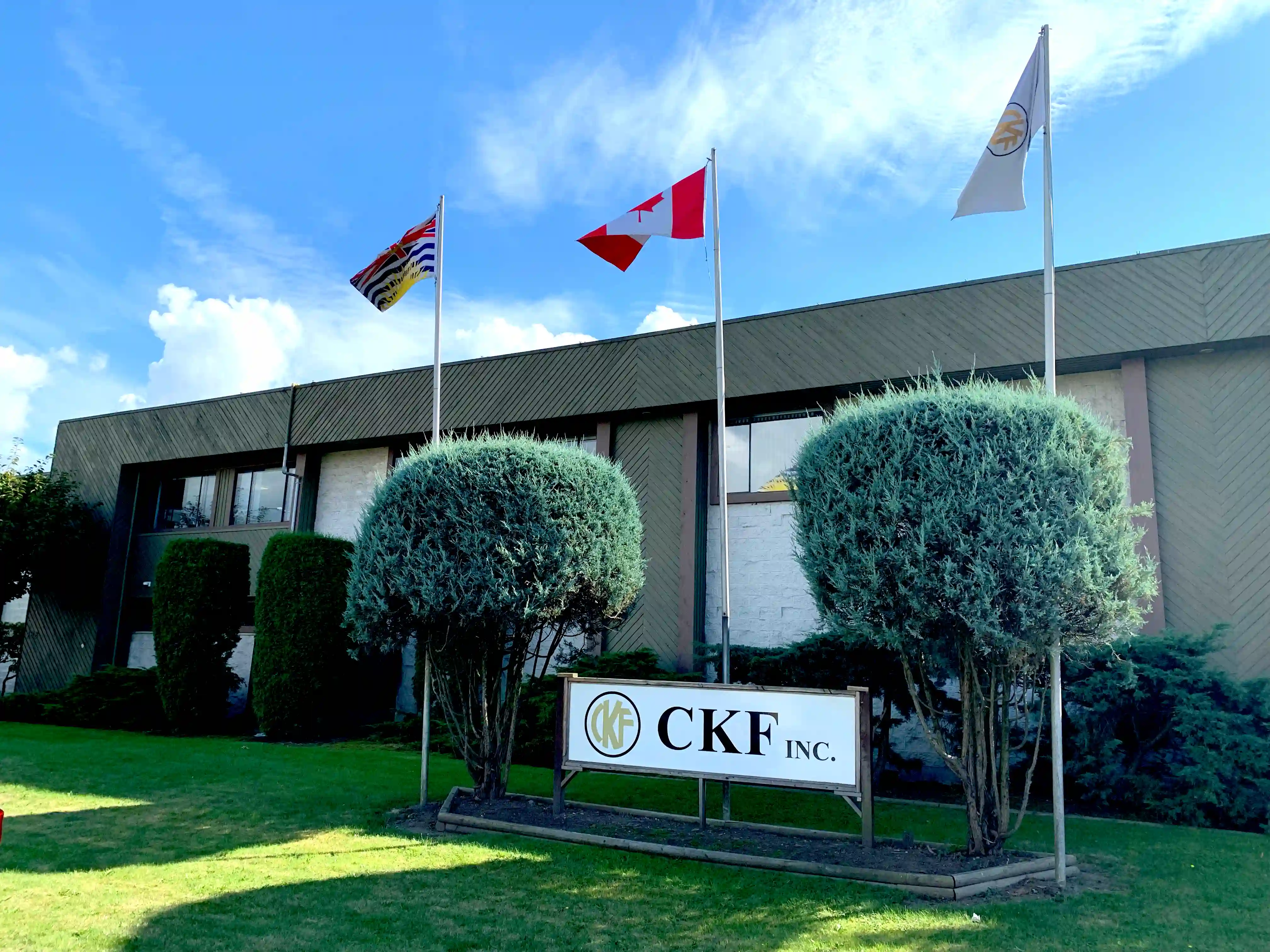 Langley Office with three flags and CKF Inc signage